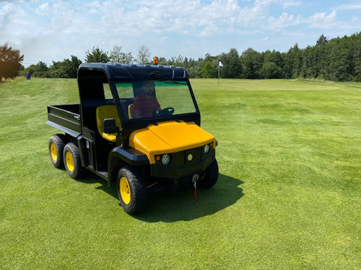 Six-wheeled electric utility vehicle in the meadow